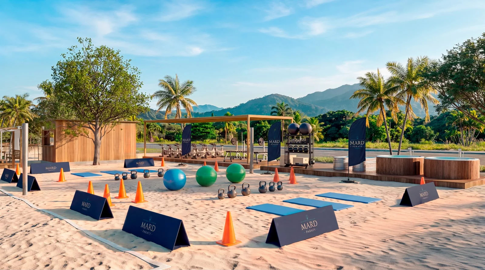 Área de treino funcional na areia, com a Arena Wellness ao fundo